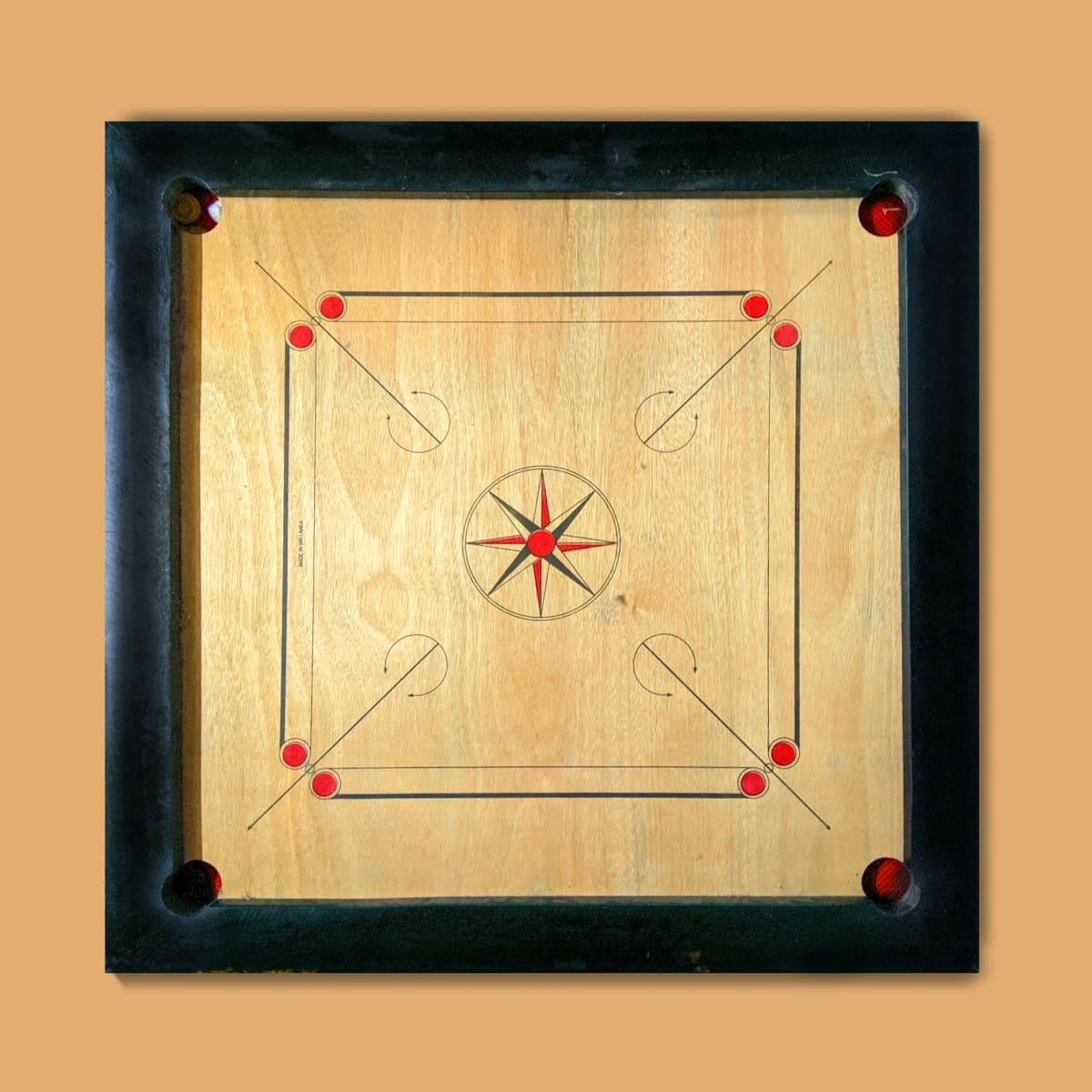 Carrom board with red and white pucks set up