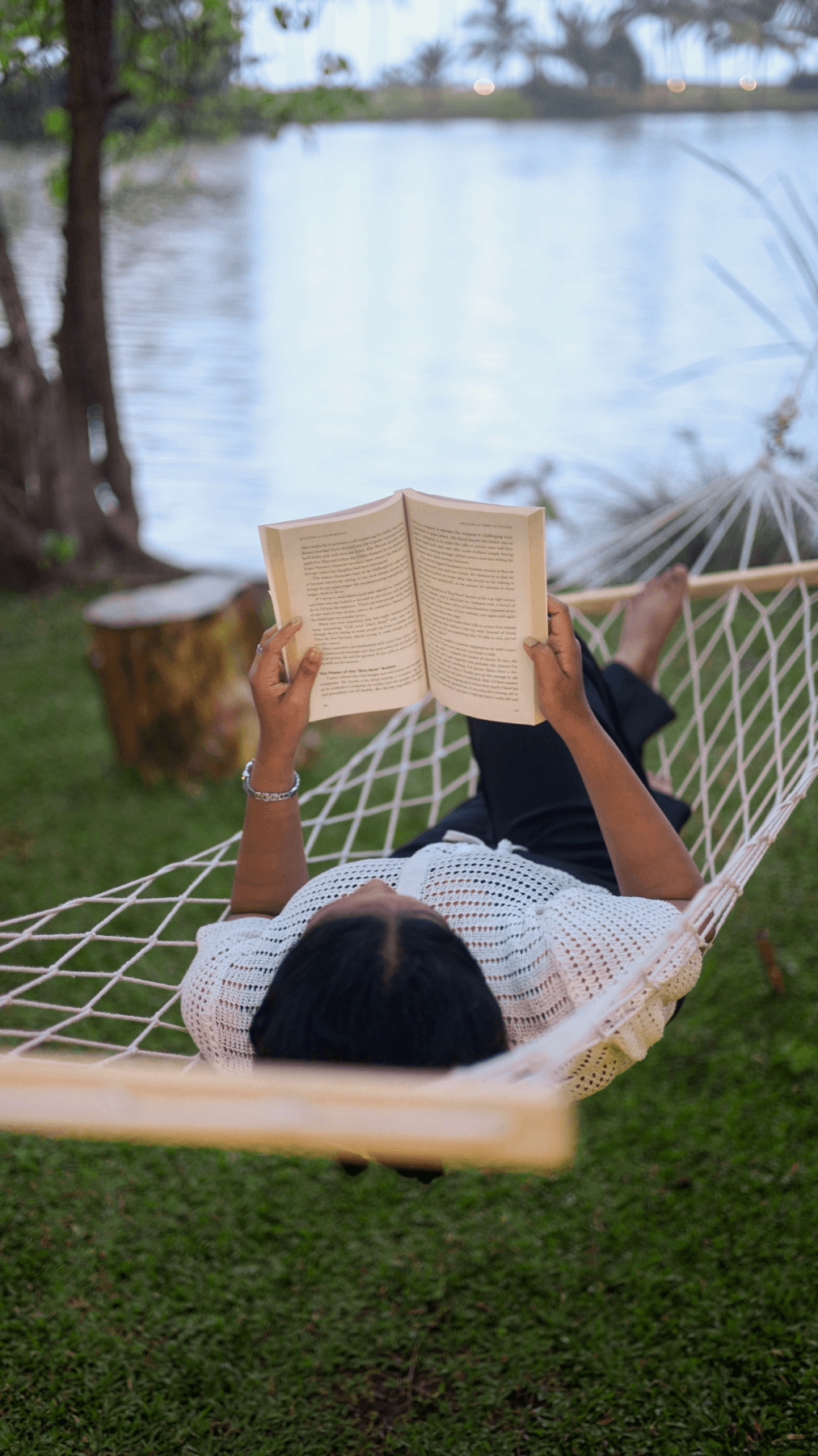 Reading in a hammock by the river