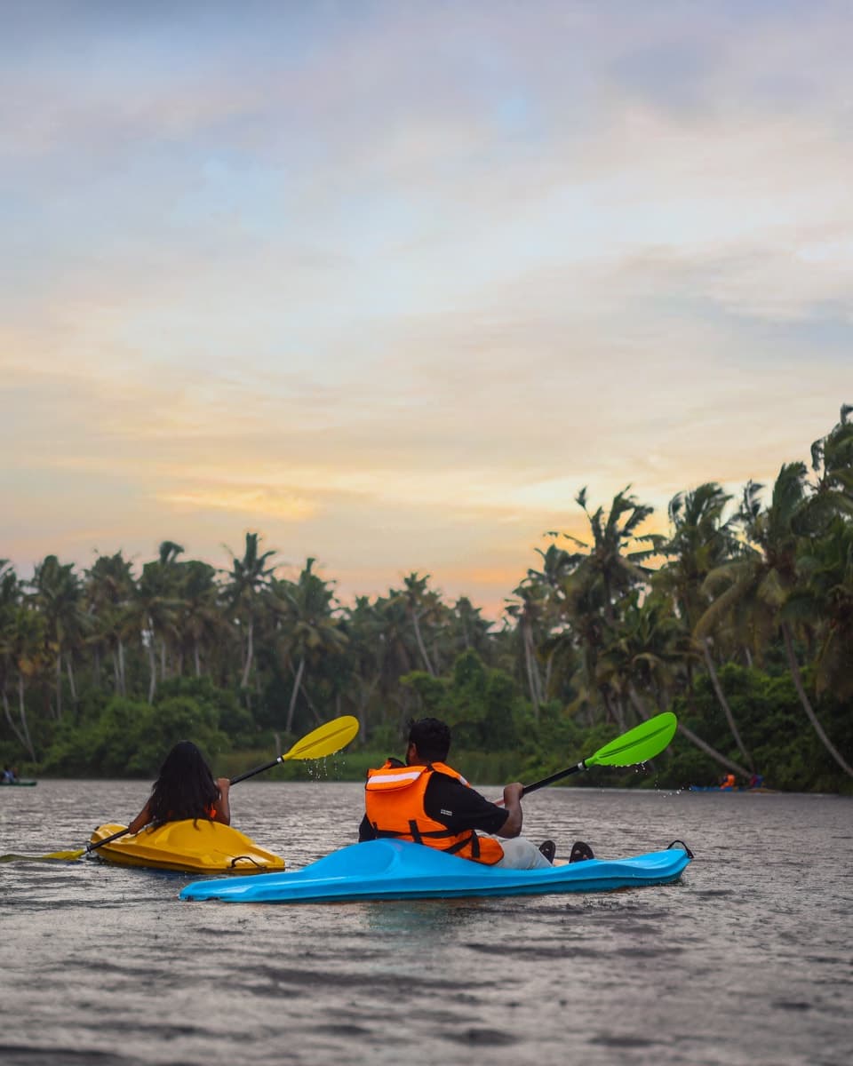 Two guests kayaking on the river at dusk